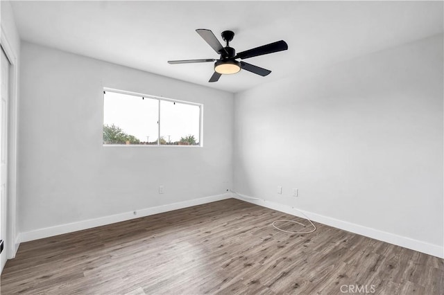 9213 Jacaranda Ave, California City, CA 93505 - spare room featuring wood finished floors and a ceiling fan