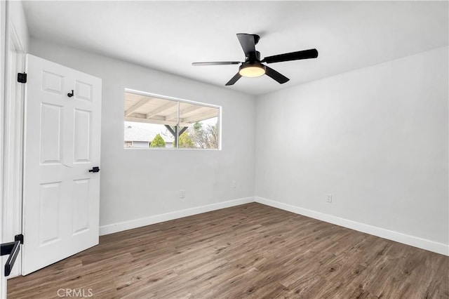 9213 Jacaranda Ave, California City, CA 93505 - empty room with wood finished floors and a ceiling fan