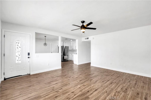 9213 Jacaranda Ave, California City, CA 93505 - unfurnished living room with wood finished floors and a ceiling fan
