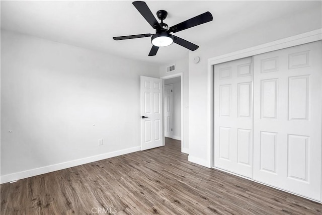 9213 Jacaranda Ave, California City, CA 93505 - unfurnished bedroom featuring wood finished floors, a closet, and ceiling fan
