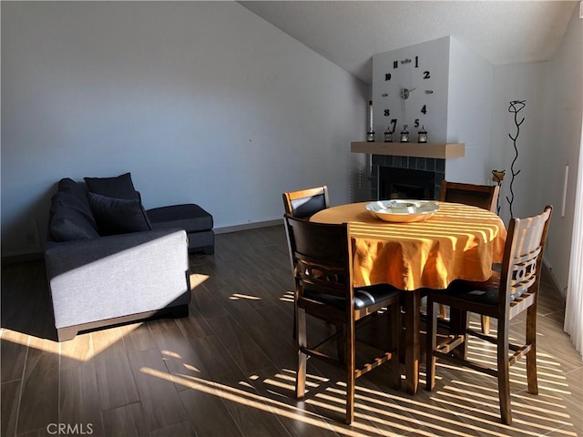 1 Appian Way Unit 710-6, San Francisco, CA 94080 - dining area featuring vaulted ceiling, a tiled fireplace, and wood tiled floors