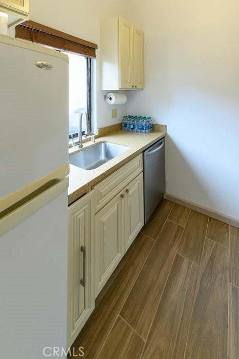 1 Appian Way Unit 710-6, San Francisco, CA 94080 - kitchen featuring freestanding refrigerator, dishwasher, wood finish floors, and light countertops
