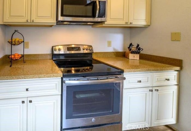 1 Appian Way Unit 710-6, San Francisco, CA 94080 - kitchen featuring stainless steel appliances, light countertops, and white cabinetry