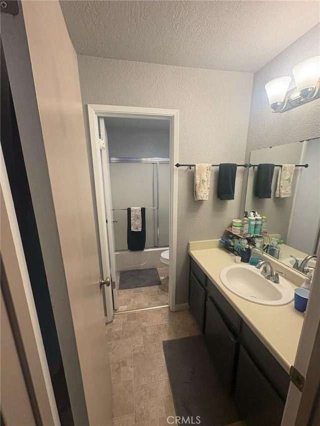 1 Appian Way Unit 710-6, San Francisco, CA 94080 - bathroom with a textured wall, vanity, a textured ceiling, and enclosed tub / shower combo