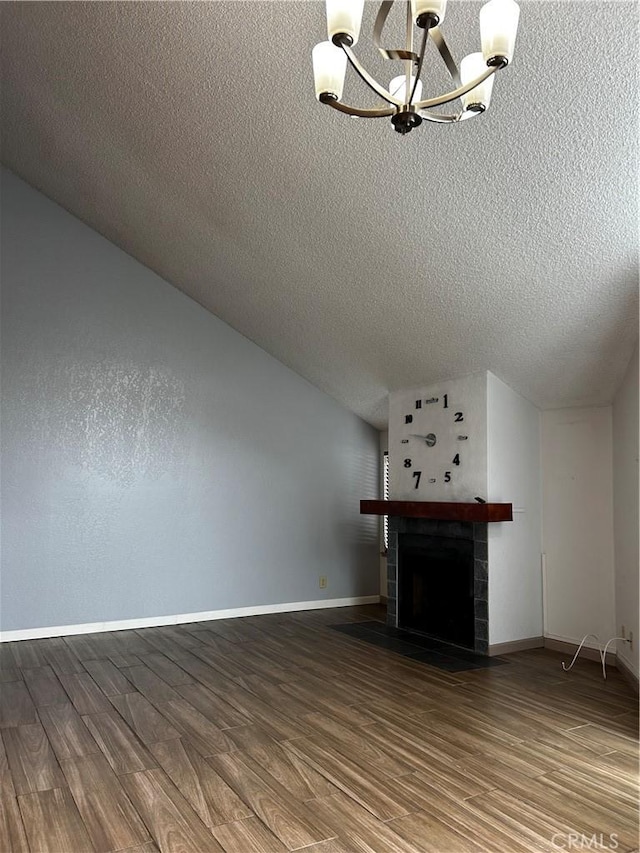 1 Appian Way Unit 710-6, San Francisco, CA 94080 - unfurnished living room featuring a chandelier, a textured ceiling, a tiled fireplace, wood finished floors, and vaulted ceiling