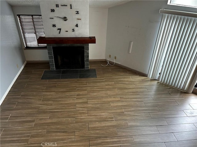 1 Appian Way Unit 710-6, San Francisco, CA 94080 - unfurnished living room featuring wood finish floors, a tiled fireplace, and a textured ceiling