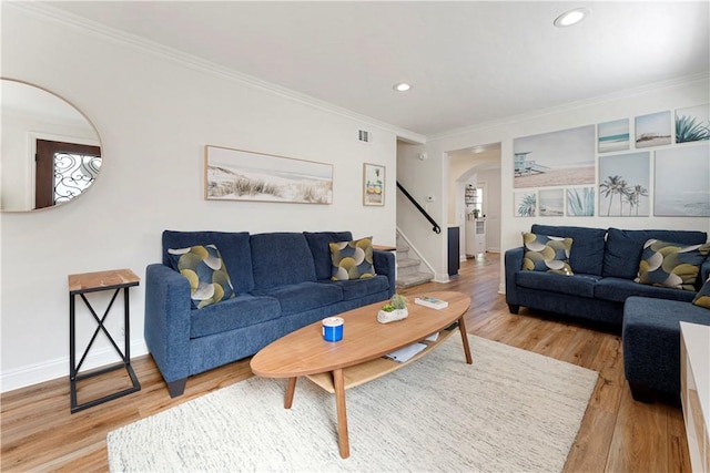 56 B Surfside Ave, Surfside, CA 90743 - living room featuring stairway, visible vents, arched walkways, light wood-style floors, and crown molding