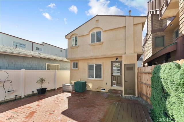 56 B Surfside Ave, Surfside, CA 90743 - rear view of property with stucco siding, a patio area, and a fenced backyard