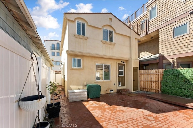 56 B Surfside Ave, Surfside, CA 90743 - rear view of property with stucco siding, fence, and a patio area