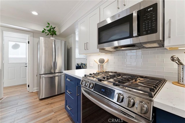 56 B Surfside Ave, Surfside, CA 90743 - kitchen featuring blue cabinets, white cabinetry, crown molding, and stainless steel appliances