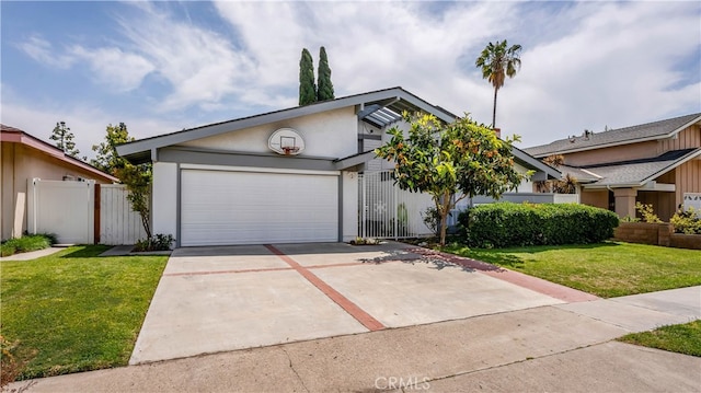 view of front facade with a front yard, a garage, concrete driveway, stucco siding, and fence