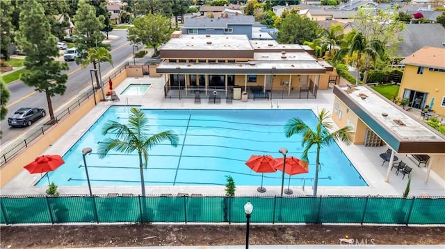 community pool featuring a patio area and fence