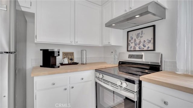 kitchen with appliances with stainless steel finishes, butcher block countertops, exhaust hood, and white cabinets