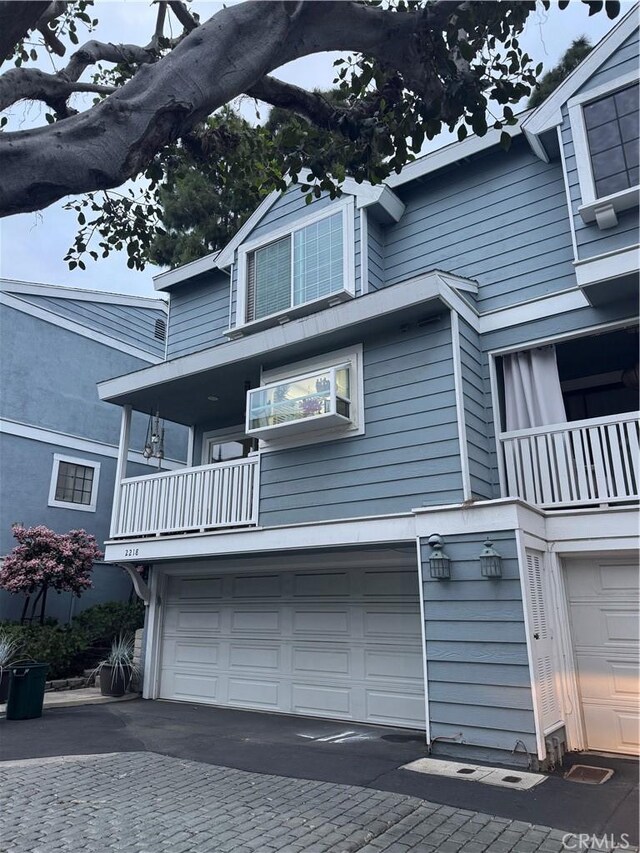 2218 Mayfair Ct, Costa Mesa, CA 92627 - view of front facade featuring a balcony and a garage