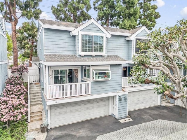 2218 Mayfair Ct, Costa Mesa, CA 92627 - view of front of house with asphalt driveway, a shingled roof, an attached garage, and stairs