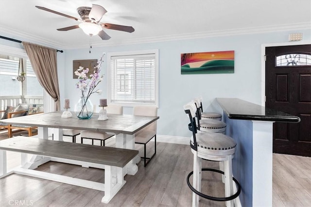 2218 Mayfair Ct, Costa Mesa, CA 92627 - dining space with a ceiling fan, light wood finished floors, crown molding, and baseboards