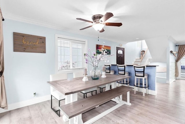 2218 Mayfair Ct, Costa Mesa, CA 92627 - dining room featuring light wood-type flooring, a ceiling fan, baseboards, stairway, and ornamental molding