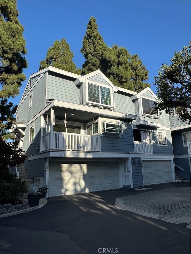 2218 Mayfair Ct, Costa Mesa, CA 92627 - multi unit property with asphalt driveway, a garage, and a balcony