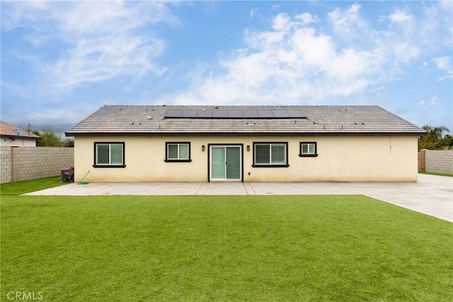 20109 Hunter St, Perris, CA 92570 - back of property featuring a fenced backyard, solar panels, a patio, and a lawn