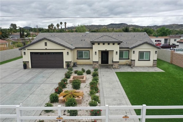 20109 Hunter St, Perris, CA 92570 - view of front facade with stucco siding, driveway, a tiled roof, and a fenced front yard