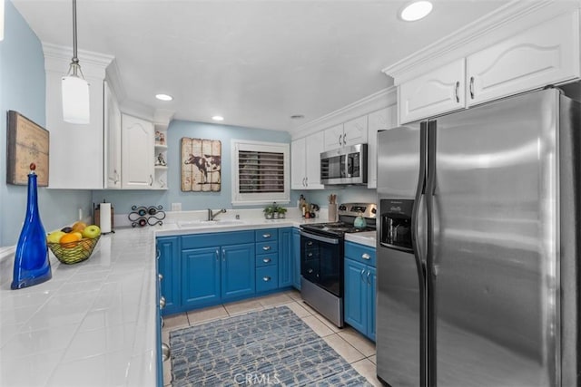 888 Ronda Sevilla Unit D, Laguna Woods, CA 92637 - kitchen with stainless steel appliances, a sink, white cabinetry, blue cabinetry, and tile countertops