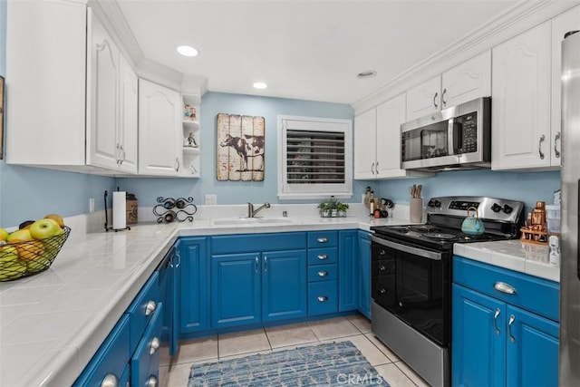 888 Ronda Sevilla Unit D, Laguna Woods, CA 92637 - kitchen with white cabinets, stainless steel appliances, a sink, and tile countertops