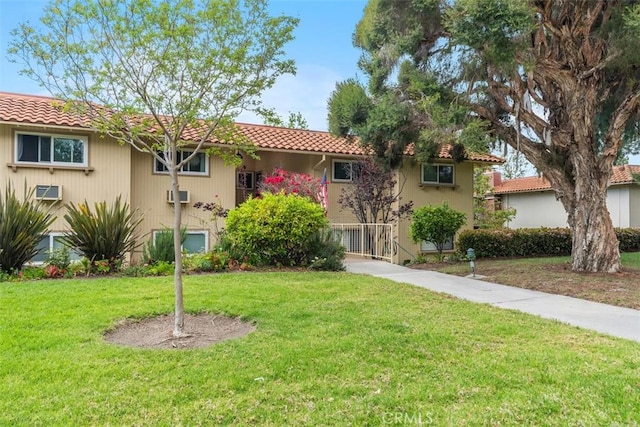 888 Ronda Sevilla Unit D, Laguna Woods, CA 92637 - view of front facade with stucco siding, a front lawn, and a tile roof