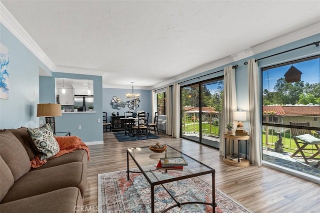 888 Ronda Sevilla Unit D, Laguna Woods, CA 92637 - living area featuring baseboards, crown molding, wood finished floors, and a chandelier
