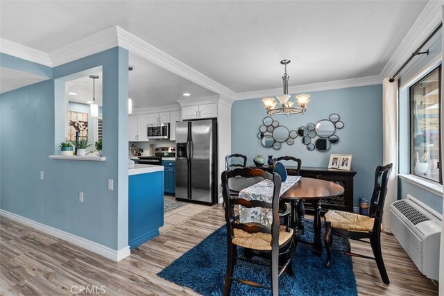 888 Ronda Sevilla Unit D, Laguna Woods, CA 92637 - dining area with baseboards, crown molding, a chandelier, and light wood-type flooring