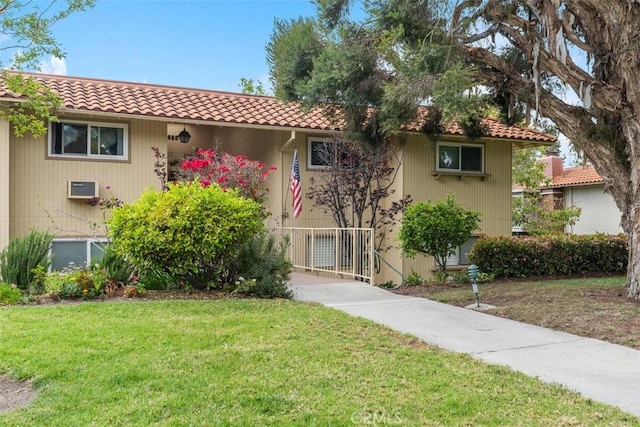 888 Ronda Sevilla Unit D, Laguna Woods, CA 92637 - view of front of home with central air condition unit, a tiled roof, and a front yard