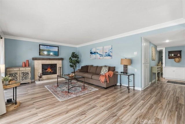 888 Ronda Sevilla Unit D, Laguna Woods, CA 92637 - living area featuring wood finished floors, a tiled fireplace, baseboards, and ornamental molding