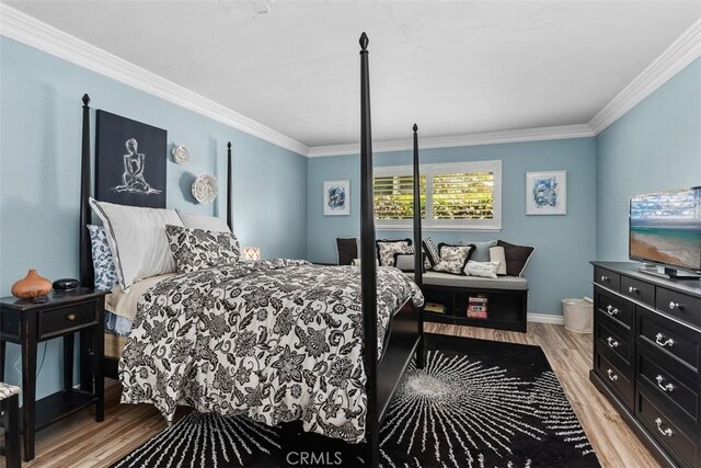 888 Ronda Sevilla Unit D, Laguna Woods, CA 92637 - bedroom with light wood-style flooring, baseboards, and ornamental molding