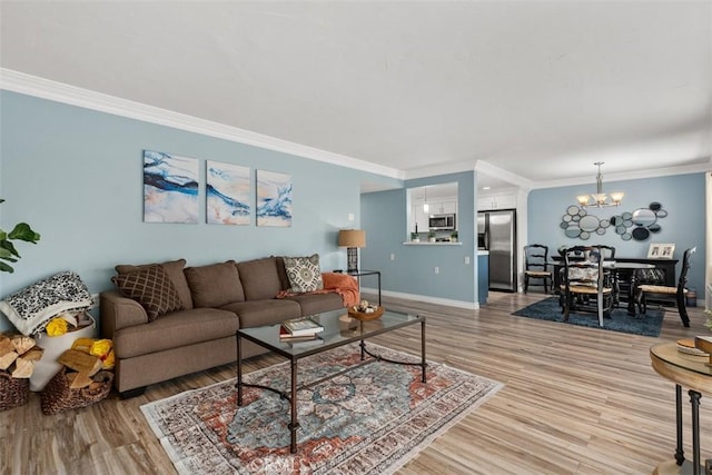 888 Ronda Sevilla Unit D, Laguna Woods, CA 92637 - living room featuring light wood-type flooring, baseboards, and crown molding