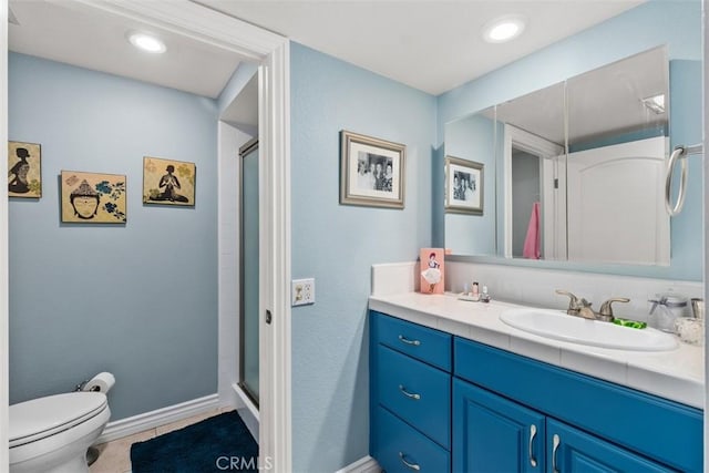 888 Ronda Sevilla Unit D, Laguna Woods, CA 92637 - full bathroom with tile patterned floors, toilet, baseboards, a shower stall, and vanity