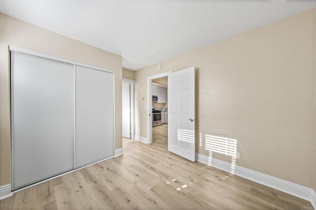 905 E 4th Ave Unit 1, National City, CA 91950 - unfurnished bedroom with baseboards, wood finished floors, and a closet