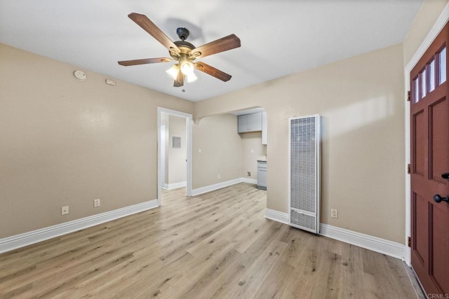 905 E 4th Ave Unit 1, National City, CA 91950 - interior space with a heating unit, baseboards, ceiling fan, arched walkways, and light wood finished floors