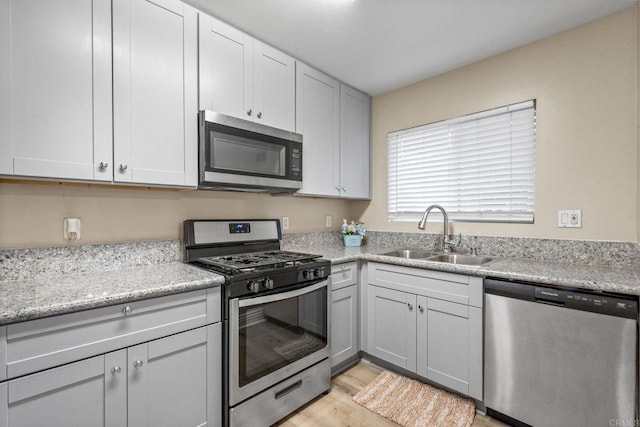 905 E 4th Ave Unit 1, National City, CA 91950 - kitchen with appliances with stainless steel finishes, a sink, and light wood-type flooring
