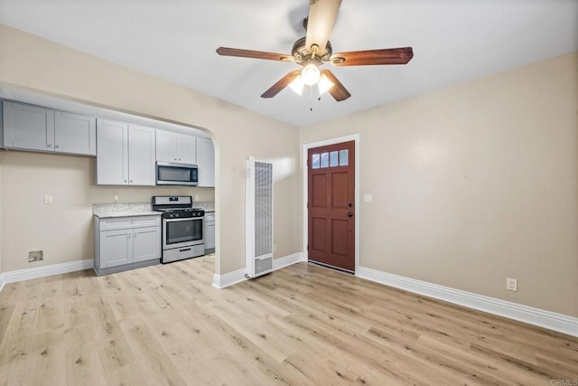 905 E 4th Ave Unit 1, National City, CA 91950 - kitchen with light wood-style floors, baseboards, stainless steel appliances, and a heating unit
