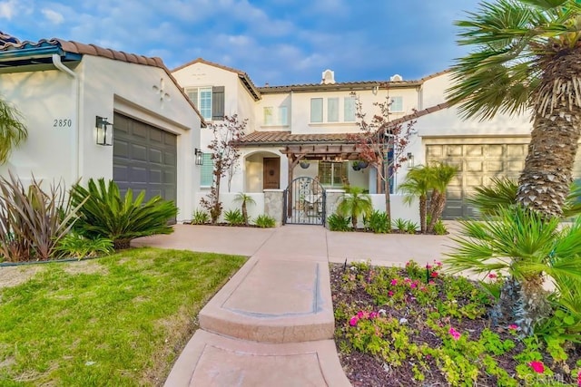 2850 Palmetto Point Ct, Chula Vista, CA 91915 - mediterranean / spanish-style home featuring a garage, a gate, stucco siding, a tile roof, and a fenced front yard