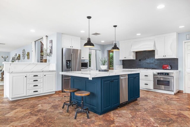 22053 Highland St, Wildomar, CA 92595 - kitchen with appliances with stainless steel finishes, premium range hood, white cabinets, recessed lighting, and a kitchen island
