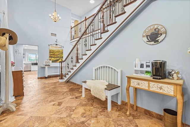 22053 Highland St, Wildomar, CA 92595 - foyer with stone finish flooring, baseboards, a chandelier, a high ceiling, and stairs