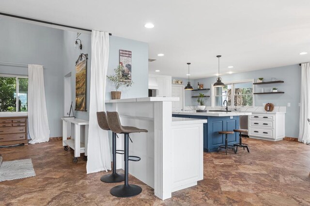 22053 Highland St, Wildomar, CA 92595 - kitchen featuring open shelves, a kitchen breakfast bar, light countertops, a sink, and blue cabinets