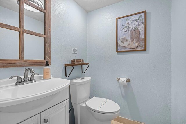 22053 Highland St, Wildomar, CA 92595 - bathroom with a textured wall, toilet, and vanity
