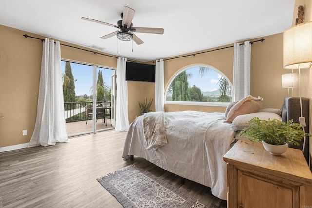 22053 Highland St, Wildomar, CA 92595 - bedroom with access to exterior, multiple windows, wood finished floors, and baseboards