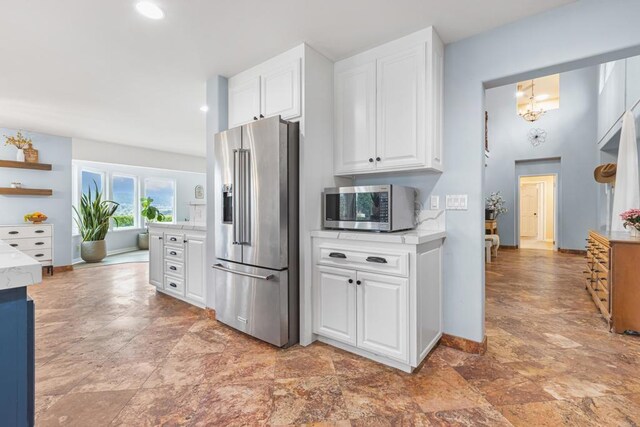 22053 Highland St, Wildomar, CA 92595 - kitchen featuring stainless steel appliances, white cabinetry, baseboards, stone finish floors, and recessed lighting