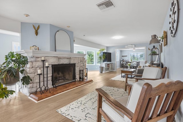 22053 Highland St, Wildomar, CA 92595 - living room featuring a fireplace, wood finished floors, and healthy amount of natural light