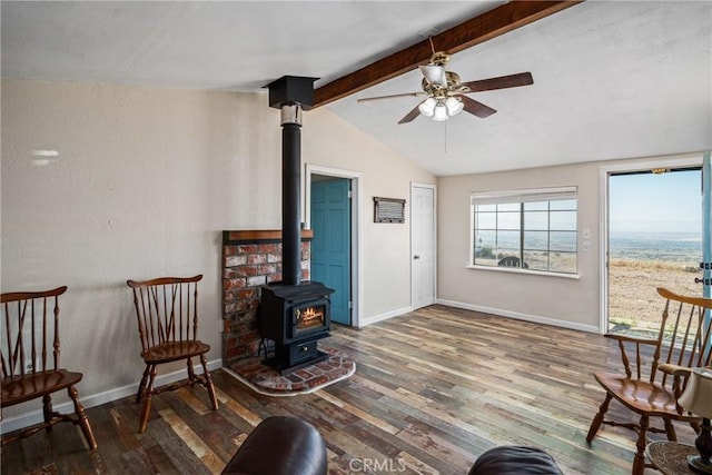 2200 E Carson Mesa Rd, Palmdale, CA 93550 - living area featuring wood finished floors, a wood stove, lofted ceiling with beams, and ceiling fan