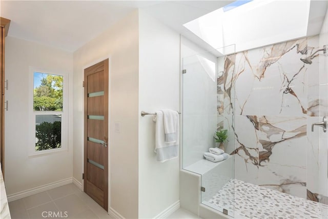 bathroom with baseboards, a marble finish shower, and tile patterned flooring