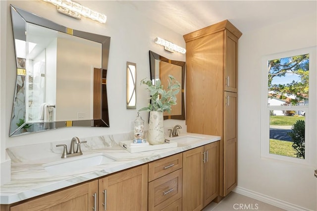 bathroom with tile patterned flooring, double vanity, and a sink