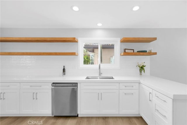 kitchen featuring open shelves, stainless steel dishwasher, a sink, decorative backsplash, and recessed lighting